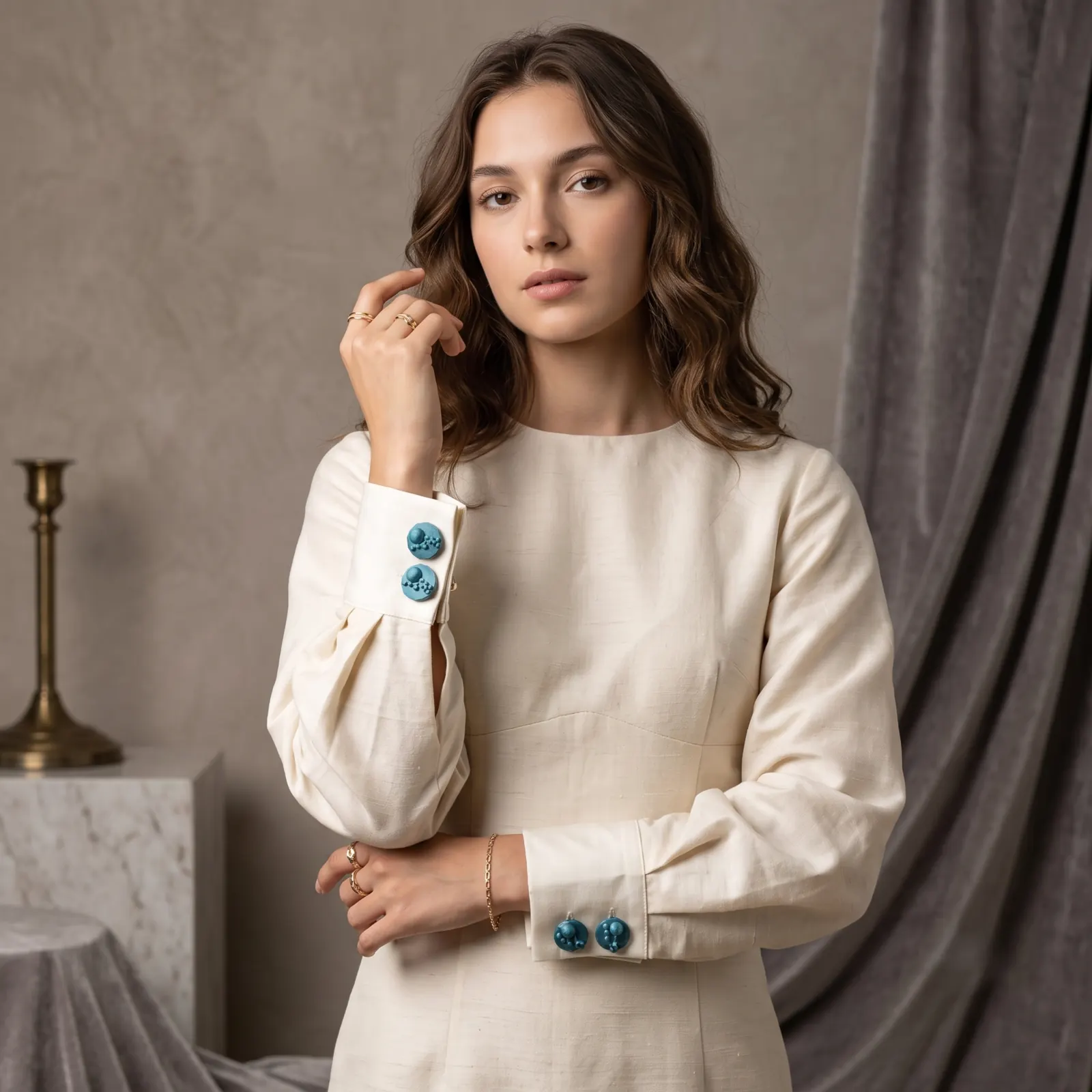 Model wearing cyan sculptural button covers