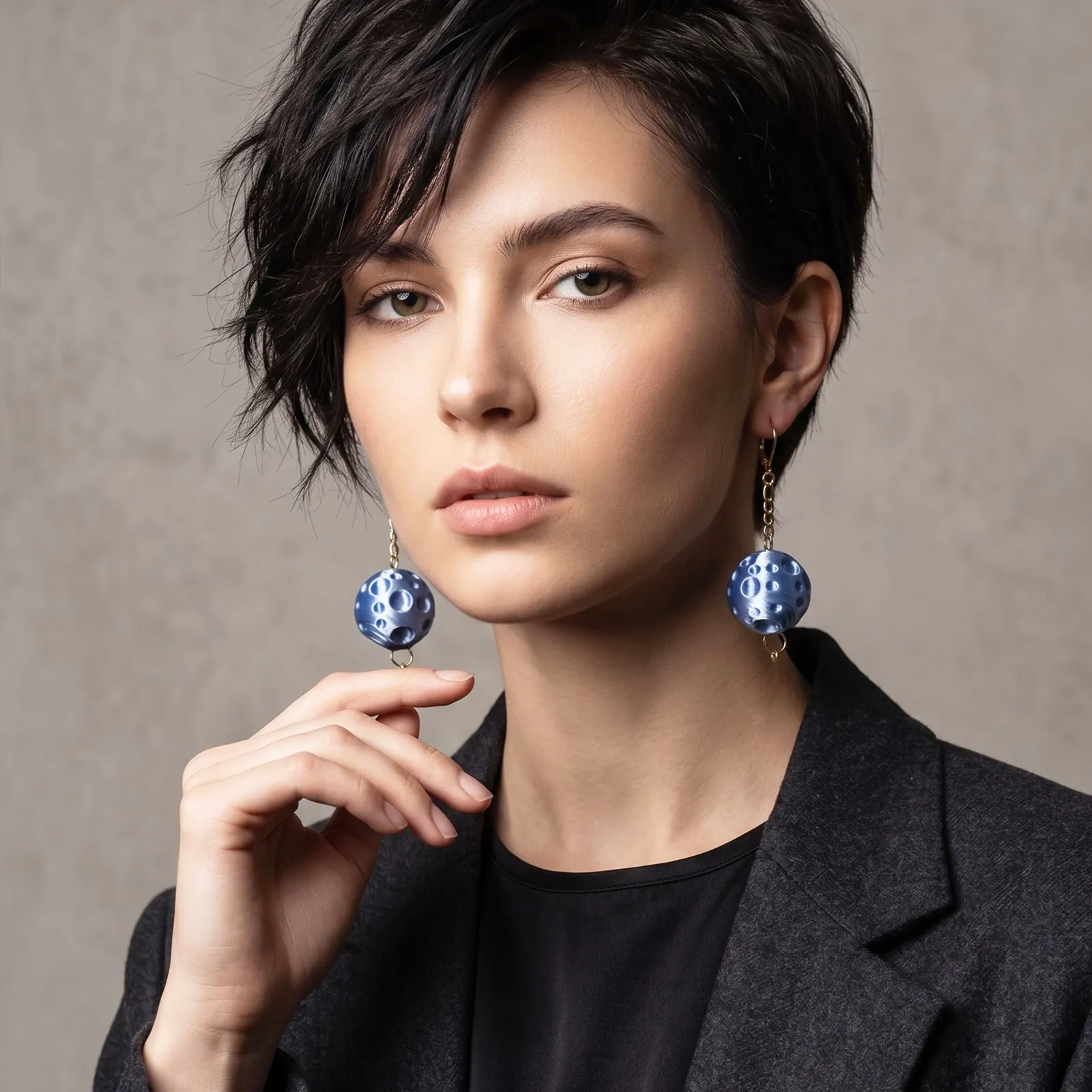 Model wearing blue sculptural Moon earrings